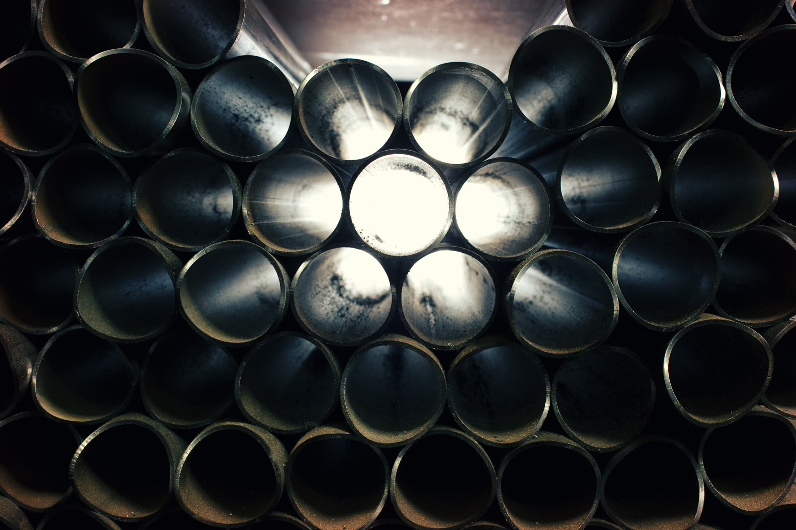 Stacked steel tube stock in the Active Force fabrication shop